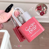 Pink lip gloss with 'Geege Bear' branding held by a hand against a neutral background.