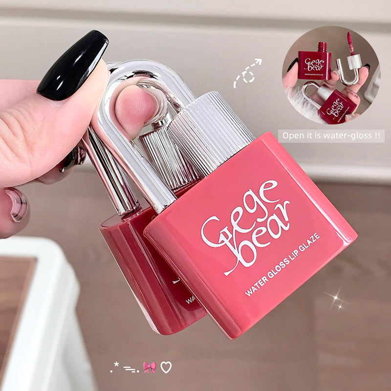 Pink lip gloss with 'Geege Bear' branding held by a hand against a neutral background.