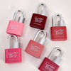 Red and pink 'Geg bear' lip glosses with lock designs on a light pink background
