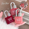 Gege Bear lip gloss glaze in lock-shaped packaging held by a hand.